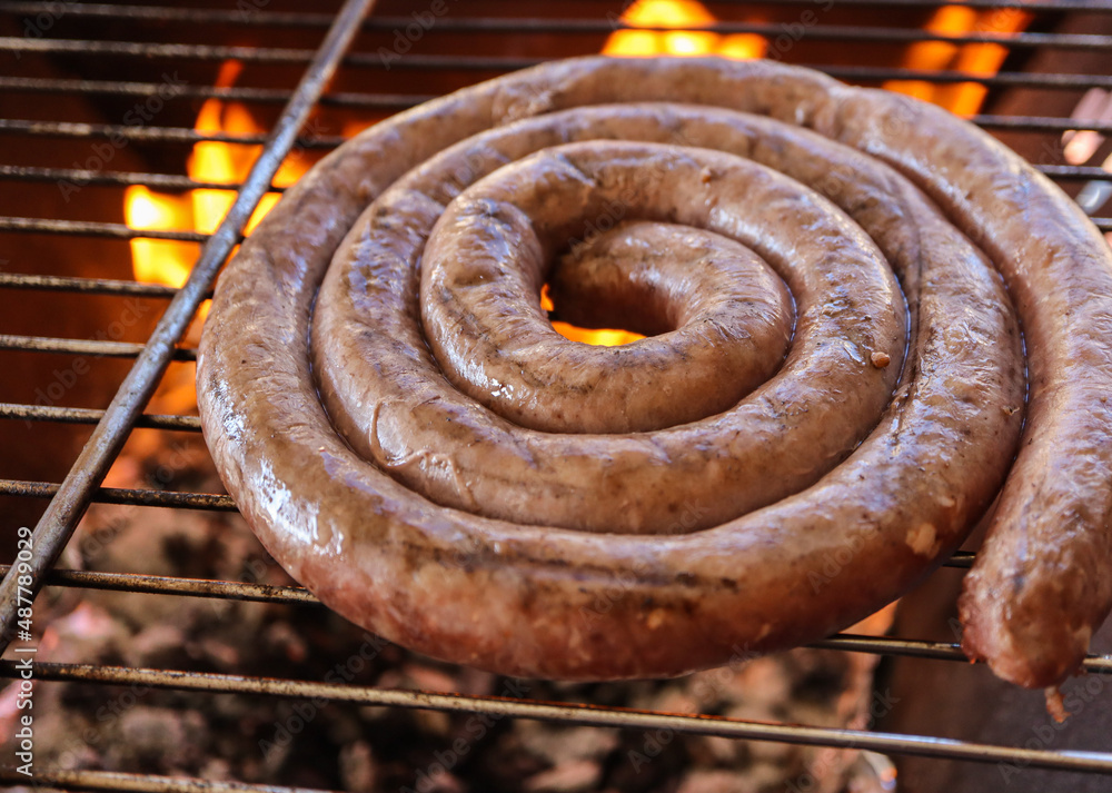 grilled sausages on the grill. South African braai, boerewors sausage
