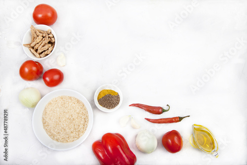 Products rice, vegetables, spices and soy meat for cooking jollof rice on a white background. National cuisine of Africa. Copy spaes.