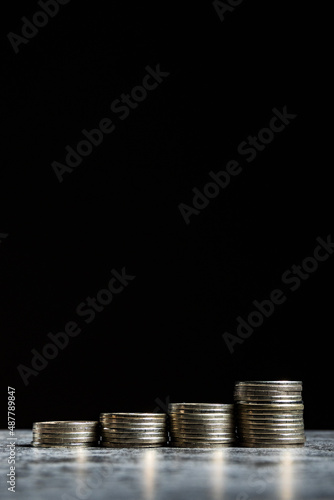 Wallpaper Mural Stacks of coins on grey table and black background like growth financial symbol Torontodigital.ca