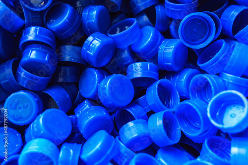Blue plastic caps used to seal beverage bottles.