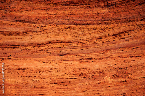 Foto Abstract ocher stone cliff wall texture background
