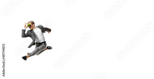 Flyer with young man in gray business suit dancing, jumping isolated on white background. Business, art, motion, action, creativity, inspiration concept. © master1305