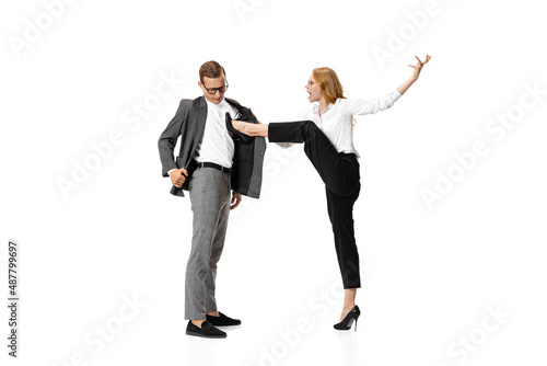 Gender inequality, Two stylish office workers in business suits in action isolated on white background. Art, beauty, fashion and business concept