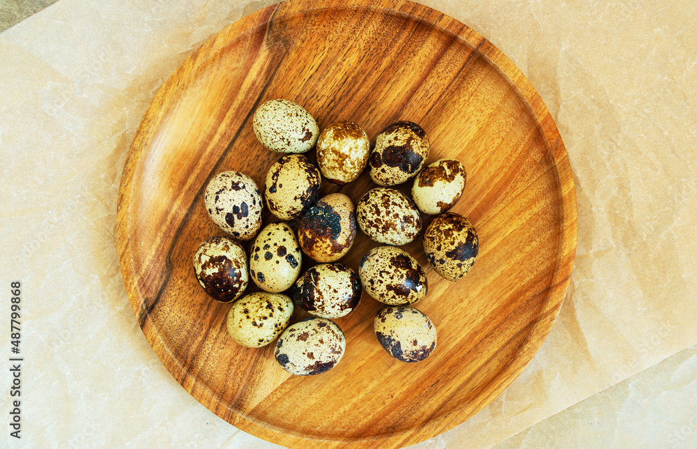 Quail eggs on a wooden plate Quail eggs on a wooden plate