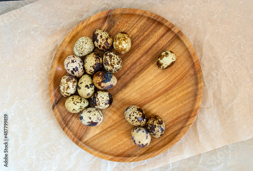 Quail eggs on a wooden plate