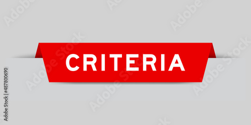 Red color inserted label with word criteria on gray background