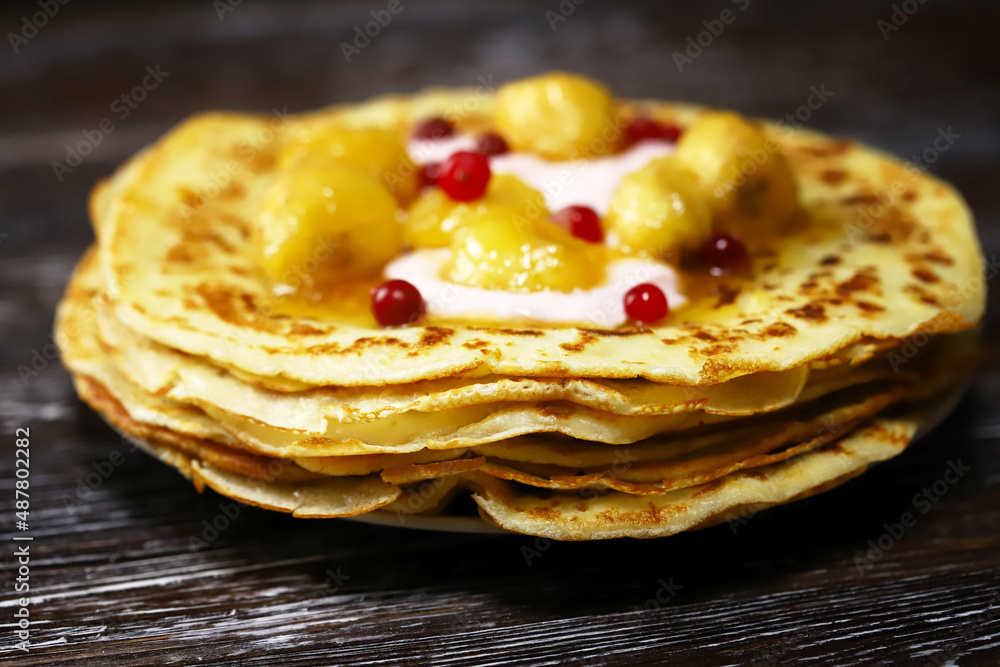 Pancakes with caramelized banana, yogurt and berries. Healthy dessert. Maslenitsa.