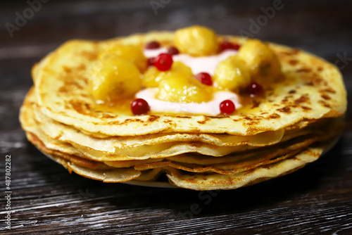 Pancakes with caramelized banana, yogurt and berries. Healthy dessert. Maslenitsa.