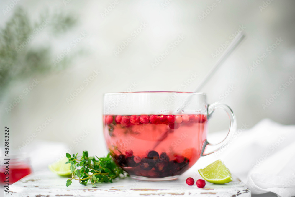 hot berry tea with blackcurrant, lingonberry and lime in a glass mug