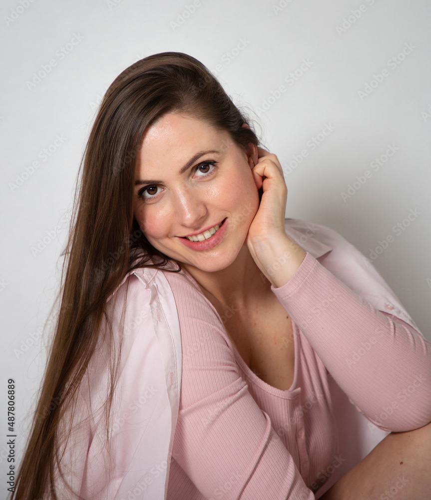 Portrait of european woman in pastel pink clothes isolated on grey Portrait of european woman in pastel pink clothes isolated on grey