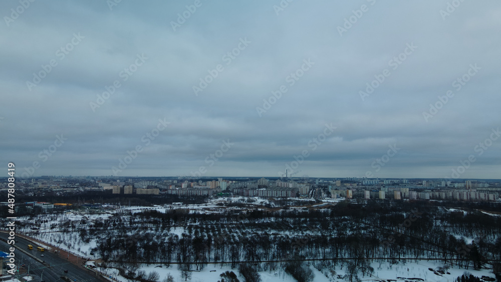 Suburb of a big city. City block from the height of the flight. Winter cityscape. Aerial photography.