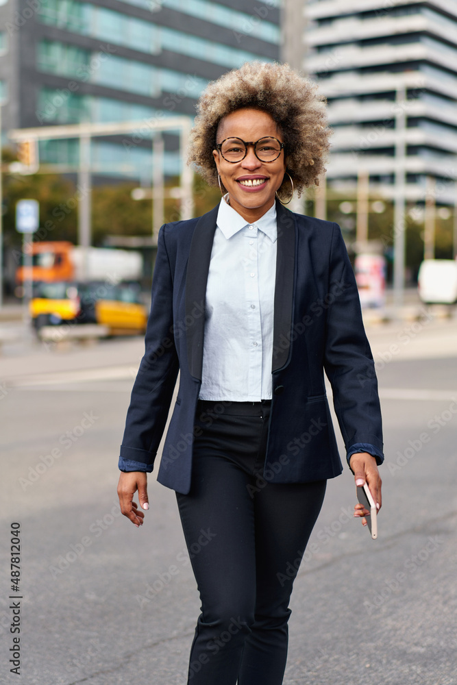 Portrait of beautiful black businesswoman wearing suit in urban background. Model of fashion with afro hairstyle. Portrait of beautiful black businesswoman wearing suit in urban background. Model of fashion with afro hairstyle.
