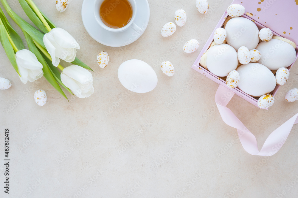 Happy easter colorful eggs in nest and flower decoration on white wood Happy easter colorful eggs in nest and flower decoration on white wood