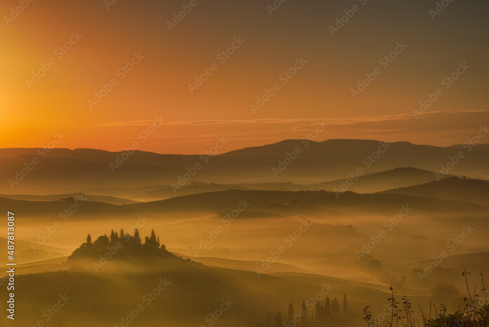 Beautiful sunrise showing trees and mountains in Tuscany, Italy