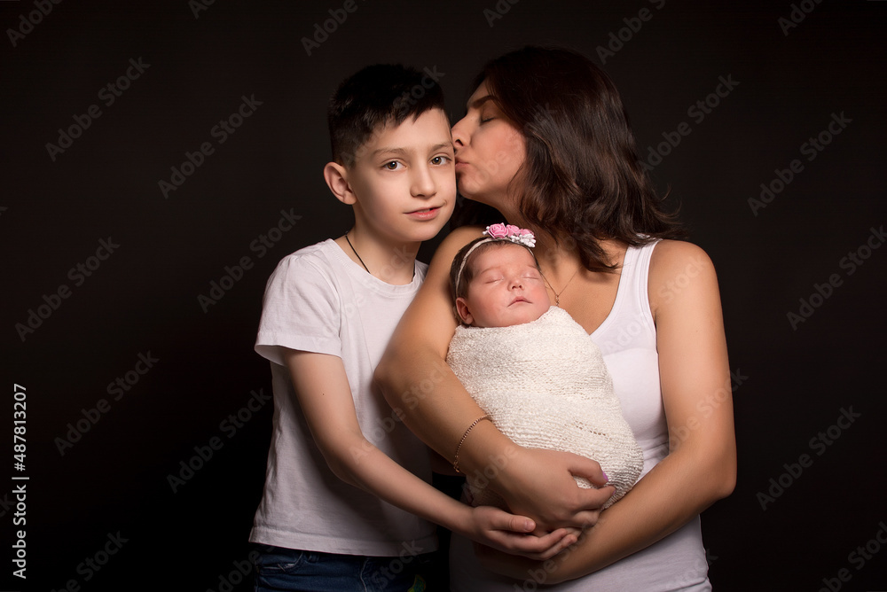mom son and daughter on a black background mom son and daughter on a black background