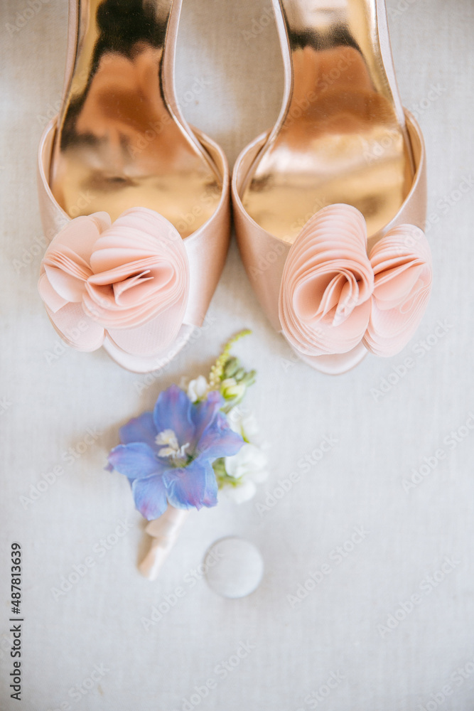 Wedding shoes on table against bridal dress Wedding shoes on table against bridal dress