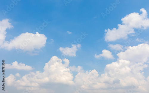 Bright blue sky with white fluffy clouds
