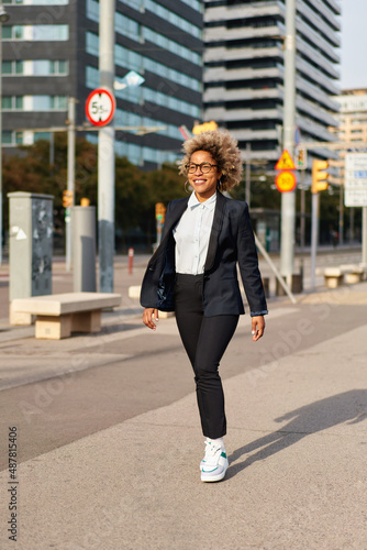 Successful professional posing near office building. Young African American business woman. Female business leader concept