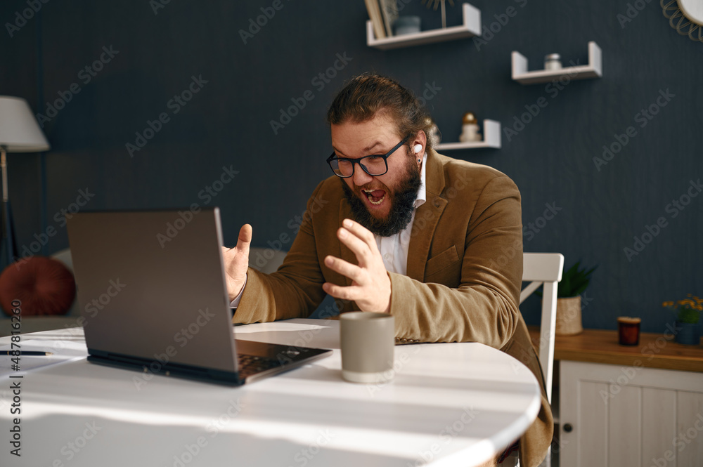 Negative frustrated guy shouting on laptop screen Negative frustrated guy shouting on laptop screen