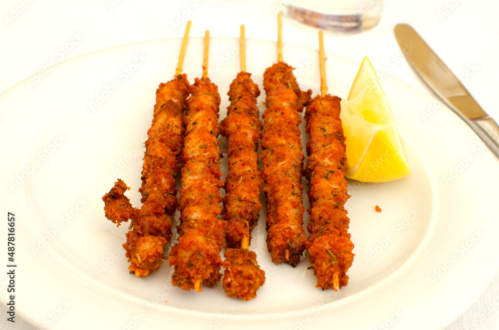 The italian dish Arrosticini di pollo fritti - skewers with chicken pieses. The italian dish Arrosticini di pollo fritti - skewers with chicken pieses.