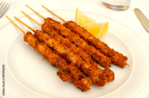 The italian dish Arrosticini di pollo fritti - skewers with chicken pieses