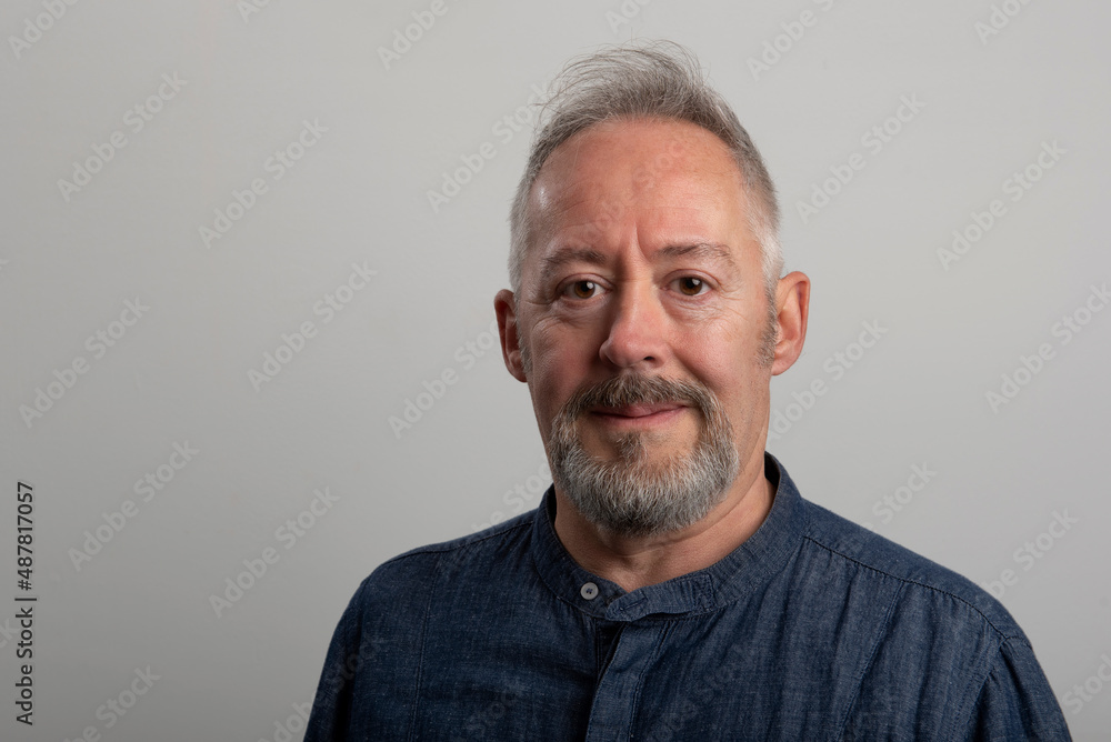 Close up photo of middle aged man, with beard and grey hair Close up photo of middle aged man, with beard and grey hair