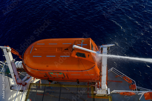 Hose pressure water test of totally enclosed lifeboat. Watertight test. Port state control. © Alexey Seafarer