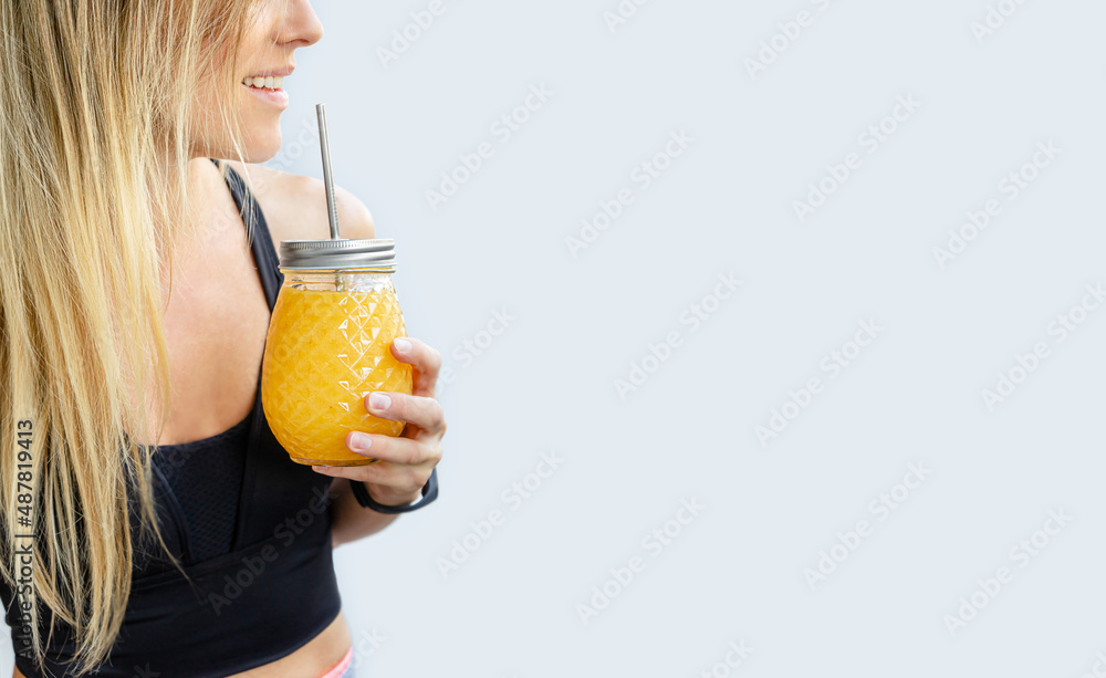 Cropped portrait of blonde smiling woman holding smoothie jar. Copy space. Cropped portrait of blonde smiling woman holding smoothie jar. Copy space.