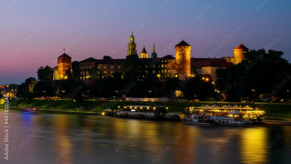 Krakow, Poland. View of old town in Krakow, Poland during the sunset. Time-lapse with moving boats and river, illuminated towers Krakow, Poland. View of old town in Krakow, Poland during the sunset. Time-lapse with moving boats and river, illuminated towers