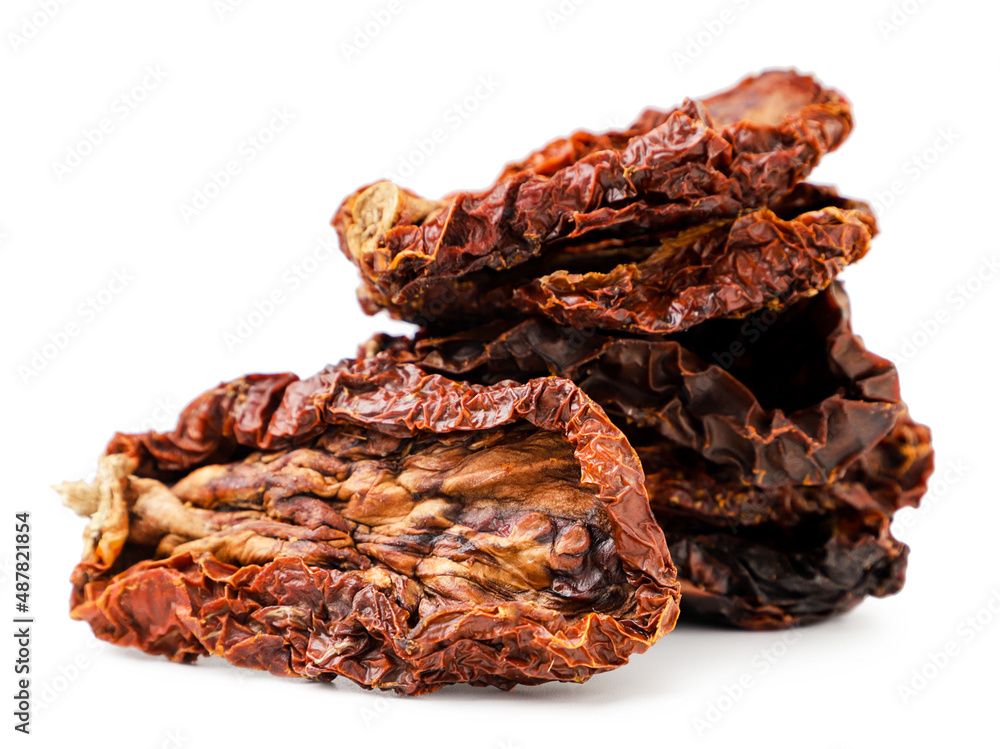 Dried tomato halves heap on a white background. Isolated