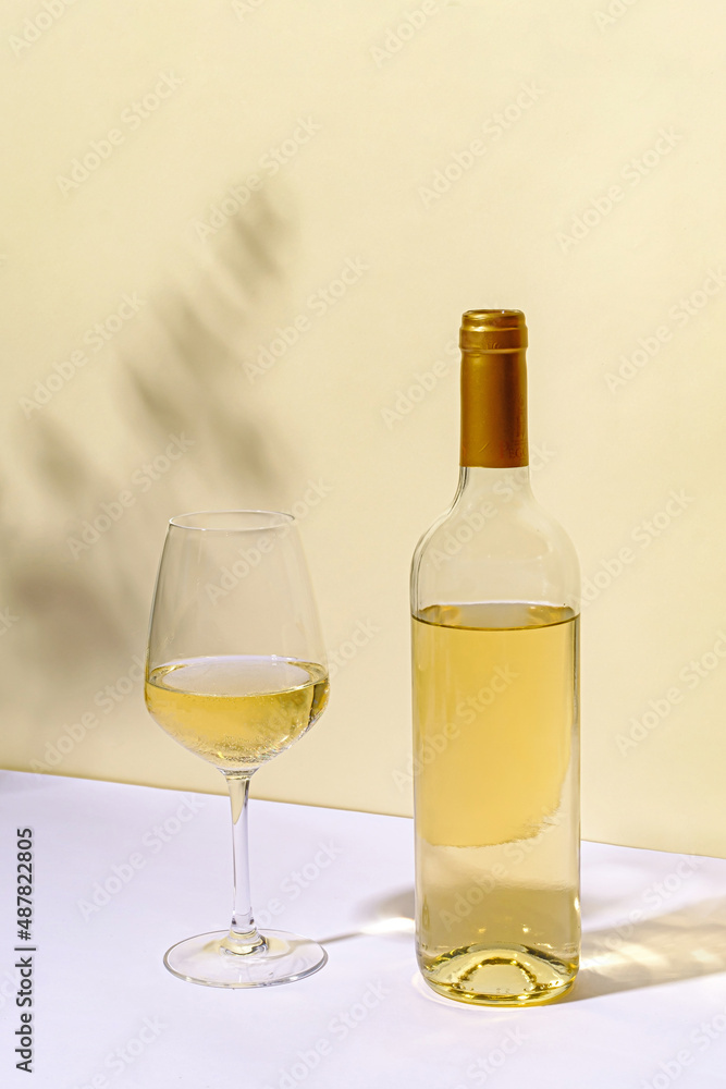 Unlabelled bottled of white wine with wineglass Unlabelled bottled of white wine with wineglass