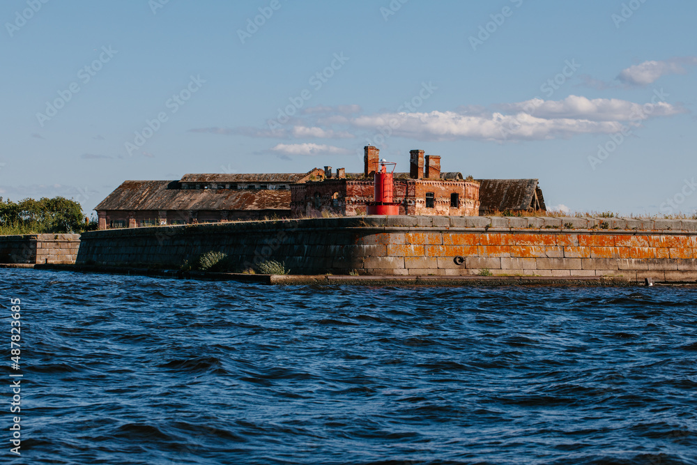 View from the water of the Kronshlot fort, the lower sash lighthouse on the island, the waters of the Gulf of Finland, the fairway of Kronstadt.