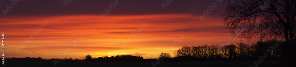 Panorama silhouettes of golden, yellow, red, orang sky in early morning in Denmark. sunrise landscapes horizon background in winter
