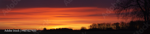 Panorama silhouettes of golden, yellow, red, orang sky in early morning in Denmark. sunrise landscapes horizon background in winter