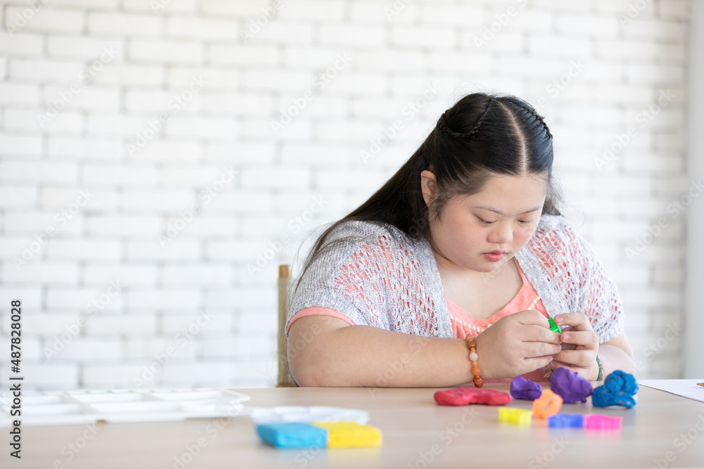 down syndrome girl sculpt plasticine figures on a table down syndrome girl sculpt plasticine figures on a table