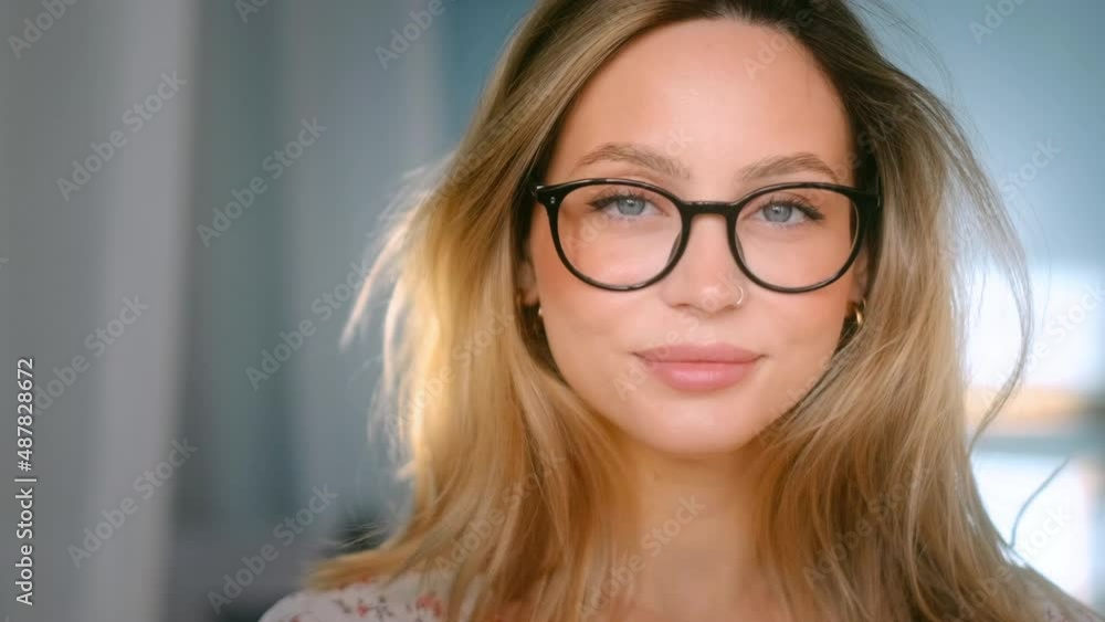 Portrait of happy smiling young attractive caucasian woman in eyeglasses looking on camera. Portrait of happy smiling young attractive caucasian woman in eyeglasses looking on camera.