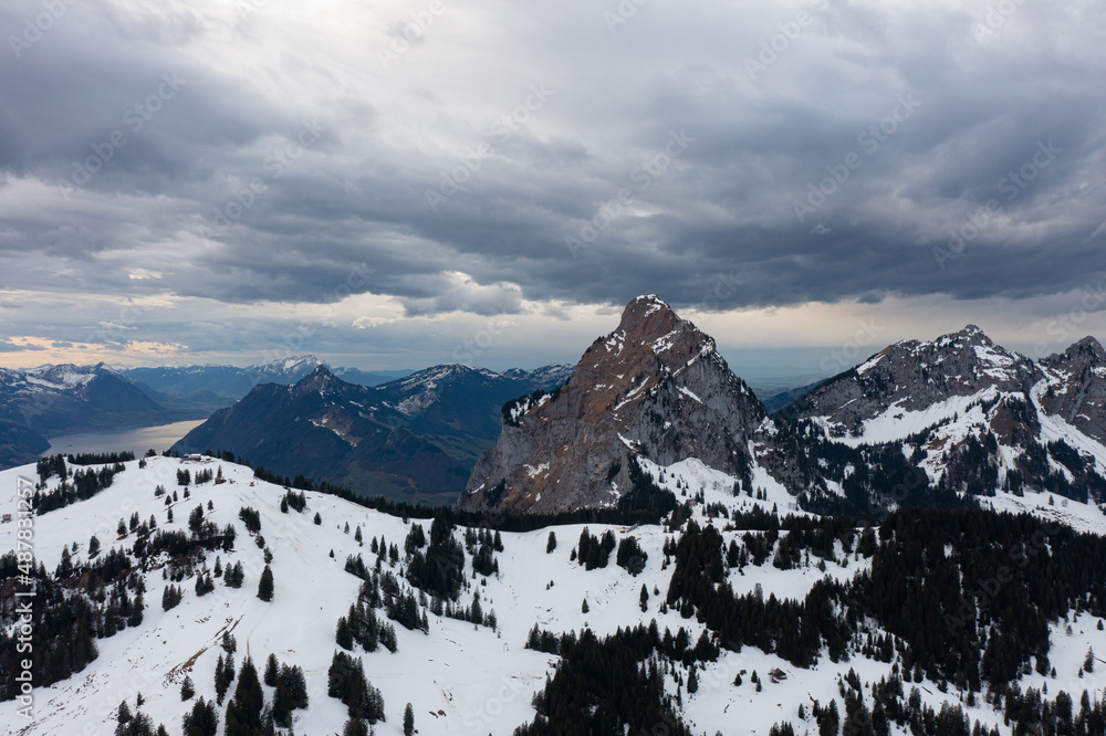 Fototapeta premium Amazing shot of a beautiful landscape in the alps of Switzerland. Wonderful flight with a drone over an amazing landscape in the canton of Schwyz. Epic view at a mountain called Grosser Mythen.