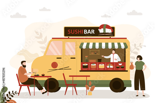 Man ordered sushi set at street diner. Chef in food truck preparing various asian dishes