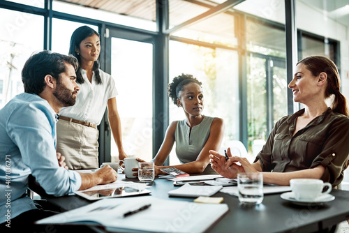 No idea is left behind. Shot of a group of colleagues having a meeting in a modern office.