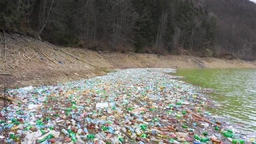 Ukraine, Kolochava. Environmental disaster in Transcarpathia. Residents of mountain villages throw plastic waste directly into the rivers,  Low ecology. Video flying drone. photo