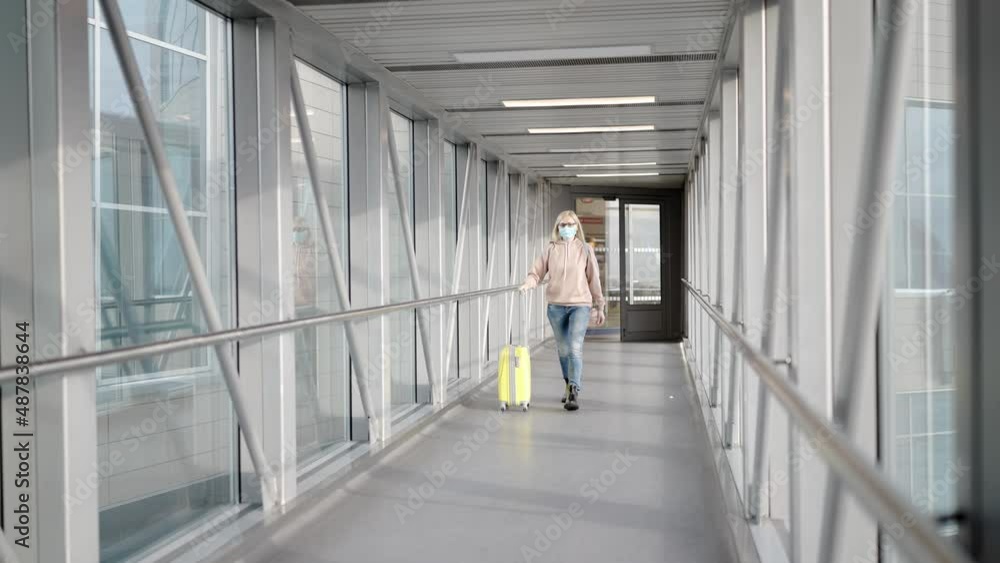 a young woman with a travel suitcase at the airport is boarding a plane. travel concept. a young woman with a travel suitcase at the airport is boarding a plane. travel concept.
