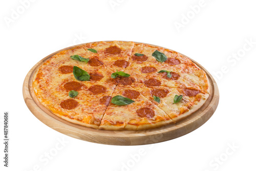 Traditional italian pepperoni pizza with salami and fresh basil leaves isolated on white background