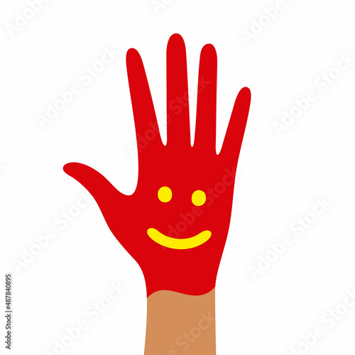 A child's hand in paint with a painted smile and eyes on a white background.