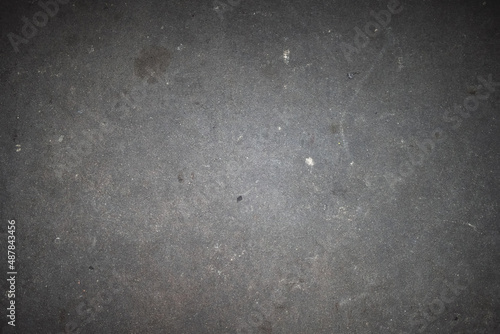 Scratched and cracked grunge concrete background with stones gravel cracks and dirt