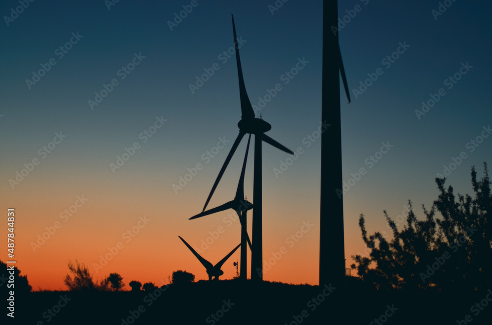 wind towers at sunset silhouette