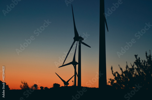 wind towers at sunset silhouette