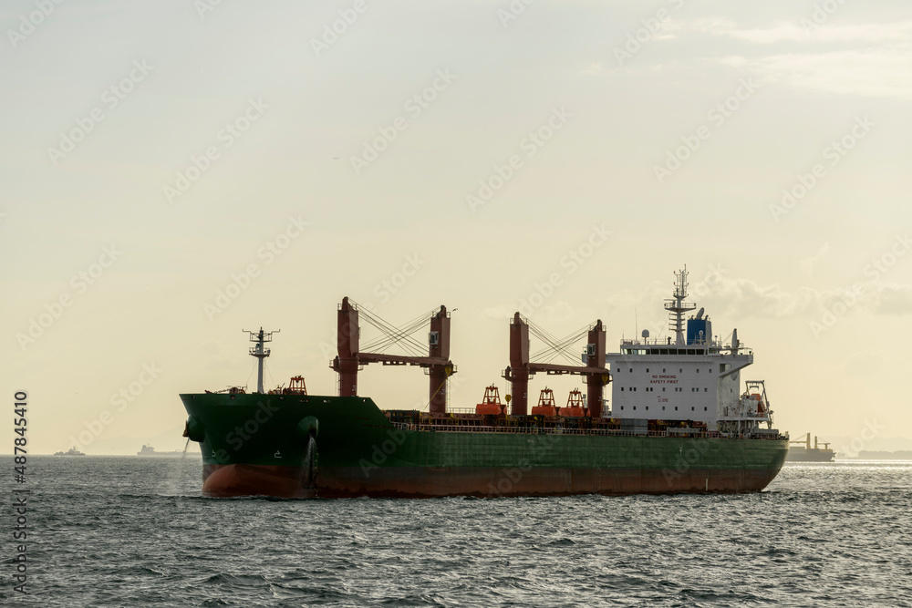 Cargo ship on the road. Bulk cargo vessel at sea. Logistics import and export business. Cargo ship on the road. Bulk cargo vessel at sea. Logistics import and export business.
