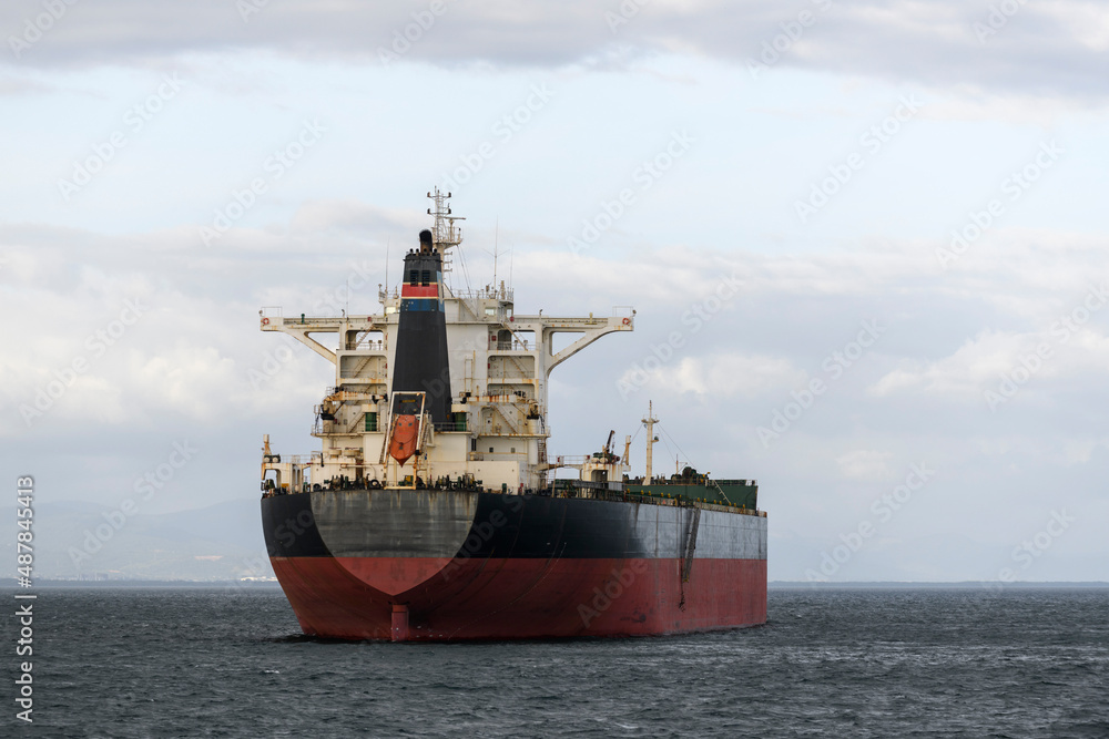 Cargo ship at anchor on the road. Bulk cargo vessel at sea. Logistics import and export business.