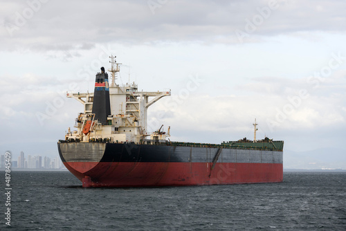 Cargo ship on the road. Bulk cargo vessel at sea. Logistics import and export business. photo