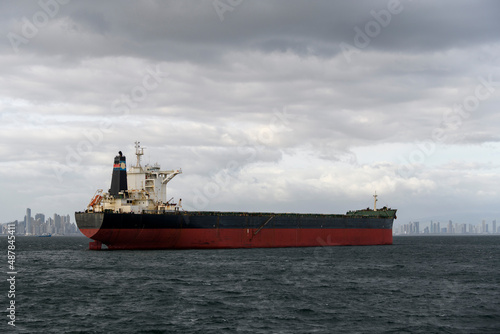 Cargo ship at anchor on the road. Bulk cargo vessel at sea. Logistics import and export business. photo